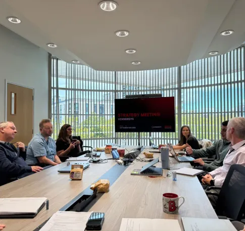 Team reviewing market briefing